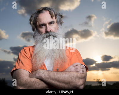 Man with beard with prison orange jumpsuit Stock Photo