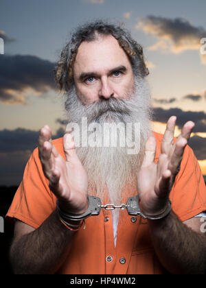 Man with beard with prison orange jumpsuit Stock Photo