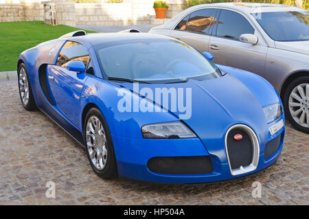 Dubai, UAE - January 08, 2012: View of a Bugatti Veyron supercar in front of Al Qasr Hotel. Veyron was named Car of the Decade Stock Photo