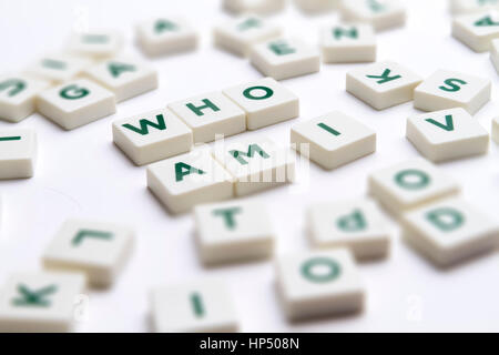 Text - Who am I made of single letter block with tilt-shift and shallow depth of field. Stock Photo