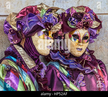 Venice, Italy- February 18th, 2012: Portrait of two persons in traditional masks and costumes during the Venice Carnival days. Stock Photo