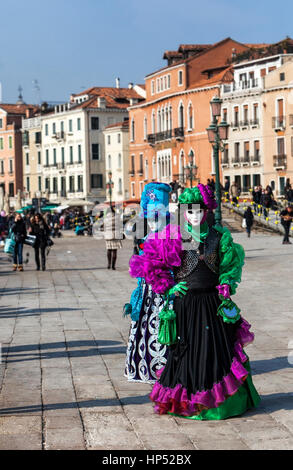 Venice, Italy- February 18th, 2012: Two disguised people posing in Sestiere Castelo during the Venice Carnival days. Stock Photo