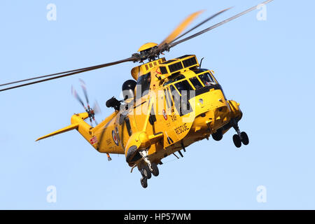 RAF Search and Rescue Sea King HAR3A from 'B' Flight, 22 Sqn at Wattisham Airfield, Suffolk making a circuit to the runway on a clear Sunday morning. Stock Photo