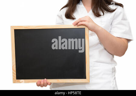 Female nurse holding a blank slate board, isolated on white background. Stock Photo