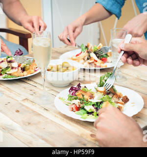Closeup of friends having a lunch together on terrace Stock Photo