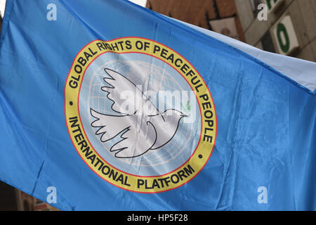 Munich, Germany. 18th Feb, 2017. A flag with the letters 'Global Rights of Peaceful People - International Platform' can be seen during a demonstration against the security conference in Munich, Germany, 18 February 2017. Photo: Felix Hörhager/dpa/Alamy Live News Stock Photo