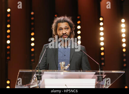Berlin, Germany. 18th Feb, 2017. Director Alain Gomis of film 'Felicite' receives Grand Jury Prize (Silver Bear) during the awarding ceremony in Berlin, capital of Germany, on Feb. 18, 2017. The 67th Berlin International Film Festival announced on Saturday jury awards to winning films selected in this year's competition section. Credit: Shan Yuqi/Xinhua/Alamy Live News Stock Photo