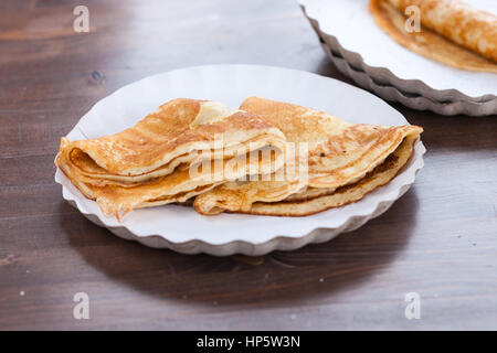 Moscow, Russia. Sunday, Feb. 19, 2017. Fresh, hot, yummy pankakes on plates. Maslenitsa, pancake, cheese fare week festival, carnival started in the city. People enjoy street performances and eat hot pancakes. This is also farewell to winter festival. The day is warm (+2C, about 36F) but gloomy. © Alex's Pictures/Alamy Live News Stock Photo