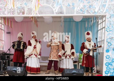 Moscow, Russia. Sunday, Feb. 19, 2017. Unidentified artists of folk music group perform on the open air stage on Tverskaya square. Maslenitsa, pancake, cheese fare week festival, carnival started in the city. People enjoy street performances and eat hot pancakes. This is also farewell to winter festival. The day is warm (+2C, about 36F) but gloomy. © Alex's Pictures/Alamy Live News Stock Photo