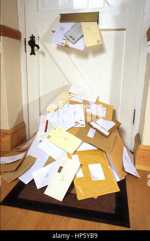 giant mound of junk mail coming through letterbox Stock Photo