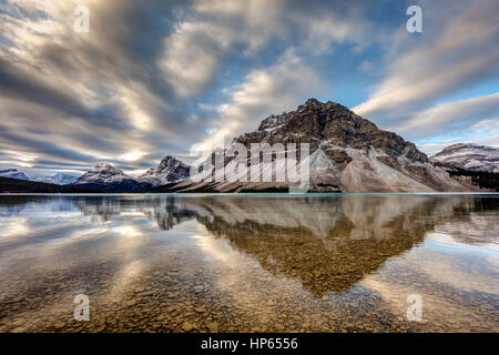 Bow Lake Reflection with mount crowfoot and a cool sky located on the very scenic Icefield Parkway Stock Photo