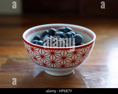 Blueberries and blackberries in a red and white bowl Stock Photo