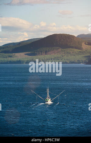 Fishing trawler at sea in blue water. Sea food vessel carry shrimps Stock Photo