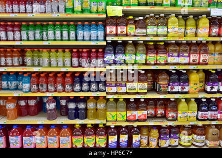 Bottles of variety of fruit juices on supermarket shelves, USA
