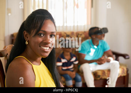 Happy black family at home. African american father, mother and child. Dad, mom and son playing virtual reality. Portrait of woman smiling at camera Stock Photo