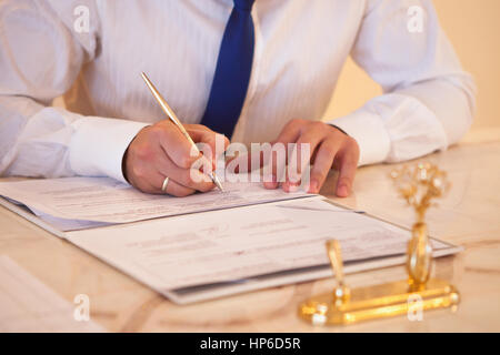 Bride and groom at the registration desk sign documents Stock Photo