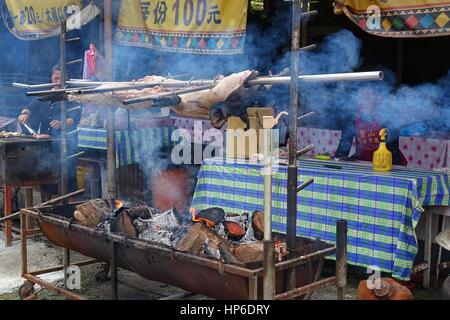 KAOHSIUNG, TAIWAN -- JULY 24, 2016: A traditional market in the aboriginal mountain village of Baoshan offers roast pig, sausages, rice cooked in bamb Stock Photo