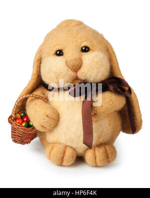 handmade toy of felt. Cute bunny with easter eggs in basket isolated on white background.Easter symbol Stock Photo