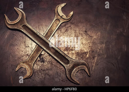 two crossed dirty wrenches on grunge background top view with place for text Stock Photo