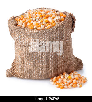 corn grains in bag isolated on white background. Corn seeds in sack. Dry uncooked corn grains for popcorn Stock Photo