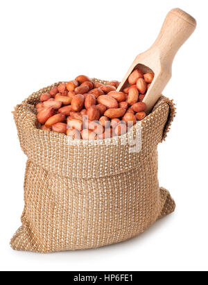 Peanut or groundnut with wooden scoop in burlap bag isolated on white background. Peanut in sack on white background. Full burlap bag of peanuts Stock Photo