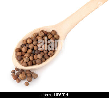 pimento peppercorns in wooden spoon isolated on white background. Whole allspice berries in wooden spoon. Myrtle pepper. Jamaica pepper. Spice of pepp Stock Photo