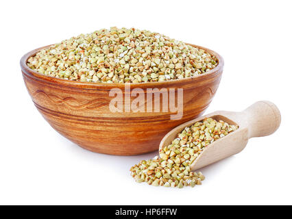Green buckwheat in clay bowl and wooden scoop isolated on a white background. Healthy food. Healthy groats Stock Photo