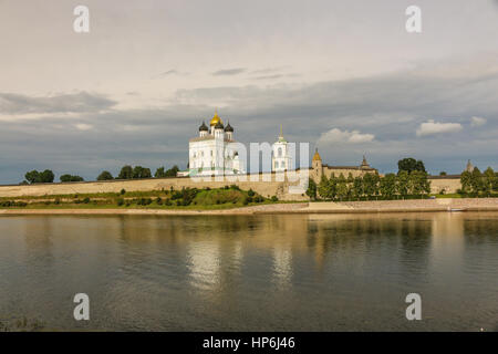 Ancient old fortress on the river bank clouds sky July 30rd 2016, Russia - Pskov Kremlin wall, Trinity Cathedral, Bell Tower and Dovmontova (Smerdya)  Stock Photo