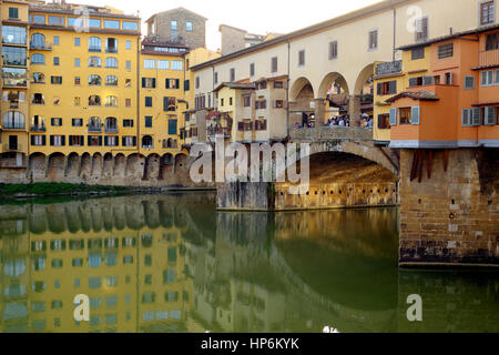 Florence, Tuscany, Italy, Europe - Angled View of Ponte Vecchio (Old Bridge) on Arno River - Beautiful Firenze architecture and reflections on water Stock Photo
