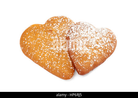 Two heart shaped gingerbread cookies with powdered sugar on white Stock Photo
