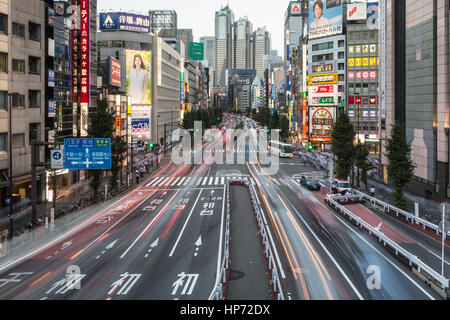 TOKYO, JAPAN - AUGUST 20, 2015: Traffic, captured with blurred motion rushes through Shinjuku, the main business district of Japan capital city, Tokyo Stock Photo