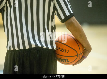 A basketball referee holding a ball during a timeout Stock Photo