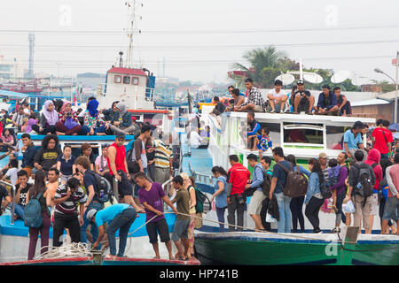 Jakarta, indonesia - September 7 2013: People squeeze themself on old wooden ferry boats in the port of Jakarta heading to the thousand island off Jak Stock Photo