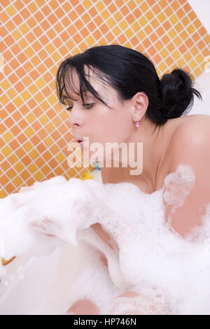 Model released, Junge Frau mit Badeschaum in der Badewanne - woman takes a bath Stock Photo