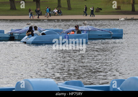 People on a pedalo on the Serpentine lake in Hyde Park, central London, as a tantalising taste of Spring is set to keep lifting spirits for many into the week ahead - although a return to wet and windy conditions with a risk of gales looms. Stock Photo