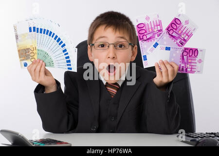 Model released, Kleiner Geschaeftsmann mit Geld - little businessman with money Stock Photo