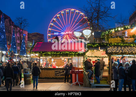 DUISBURG, GERMANY - DECEMBER 17, 2016: Unknown people at traditional christmas market with illuminated ferris wheel in the center of Duisburg, Germany Stock Photo