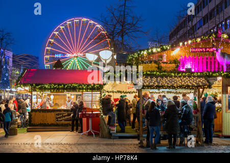 DUISBURG, GERMANY - DECEMBER 17, 2016: Unknown people at traditional christmas market with illuminated ferris wheel in the center of Duisburg, Germany Stock Photo