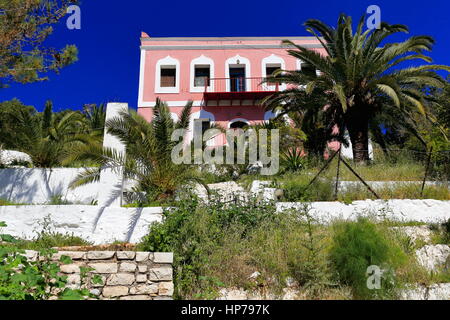 Two storied-neoclassical pink painted house with red metal balcony and orchard of palm trees. Pera Meria district to the west side of the main harbor- Stock Photo