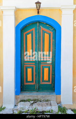 Blue-green-yellow wooden door of a restored neoclassical house-backstreet of the main harbor area-center of town district to the S.of the waterfront.  Stock Photo