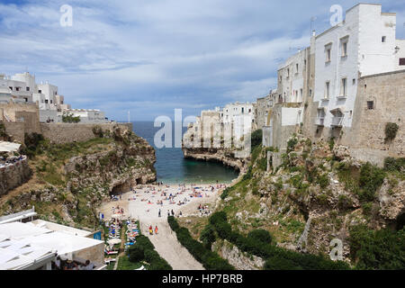 Polignano a Mare, Italy – June 3, 2016: People bathing in the Mediterranean Sea at the city beach of Polignano a Mare, beach town in Puglia, southern  Stock Photo
