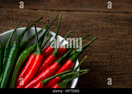 hot chili peppers on a wooden board Stock Photo