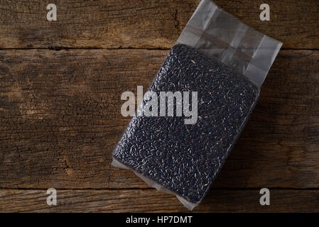 rice berry in vacuum bag on wood background Stock Photo