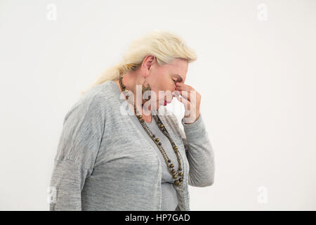 Woman having nose ache. Lady touching her nose isolated. How to cure sinusitis. Stock Photo