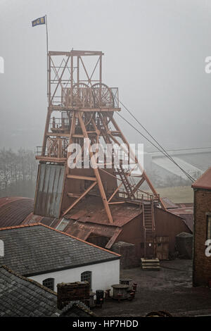 Big Pit Welsh coal mine winding tower under grey sky Stock Photo