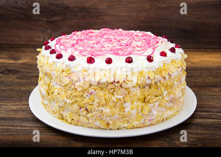 Sponge cake with almonds, whipped cream and berries. Studio Photo Stock Photo