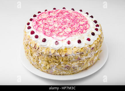 Sponge cake with almonds, whipped cream and berries. Studio Photo Stock Photo