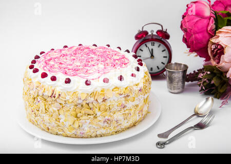 Sponge cake with almonds, whipped cream and berries. Studio Photo Stock Photo