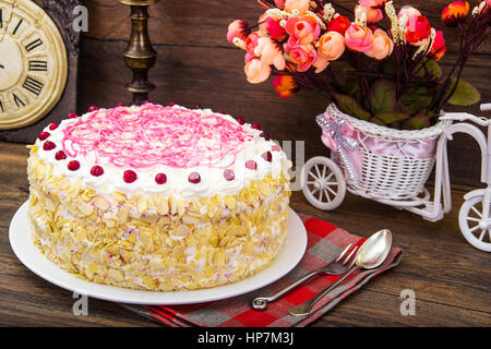 Sponge cake with almonds, whipped cream and berries. Studio Photo Stock Photo