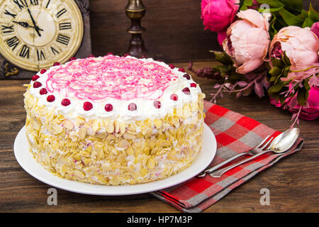 Sponge cake with almonds, whipped cream and berries. Studio Photo Stock Photo